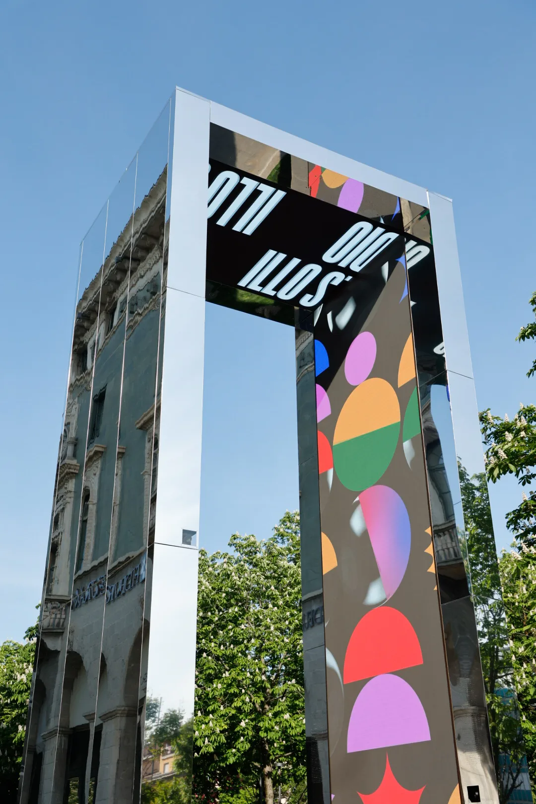 A very tall building with a very colorful sign on it's side.