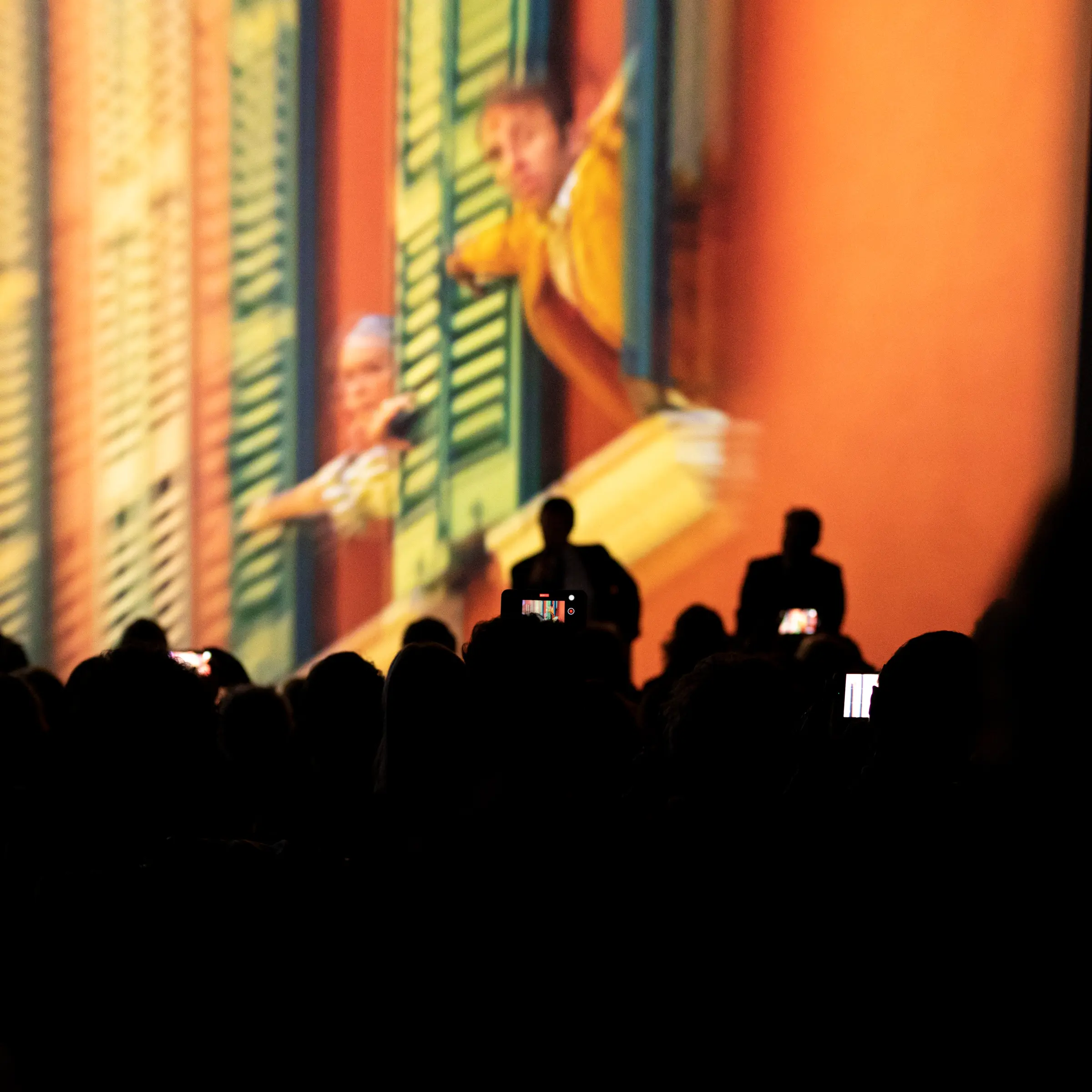 A man standing in front of a projection screen.