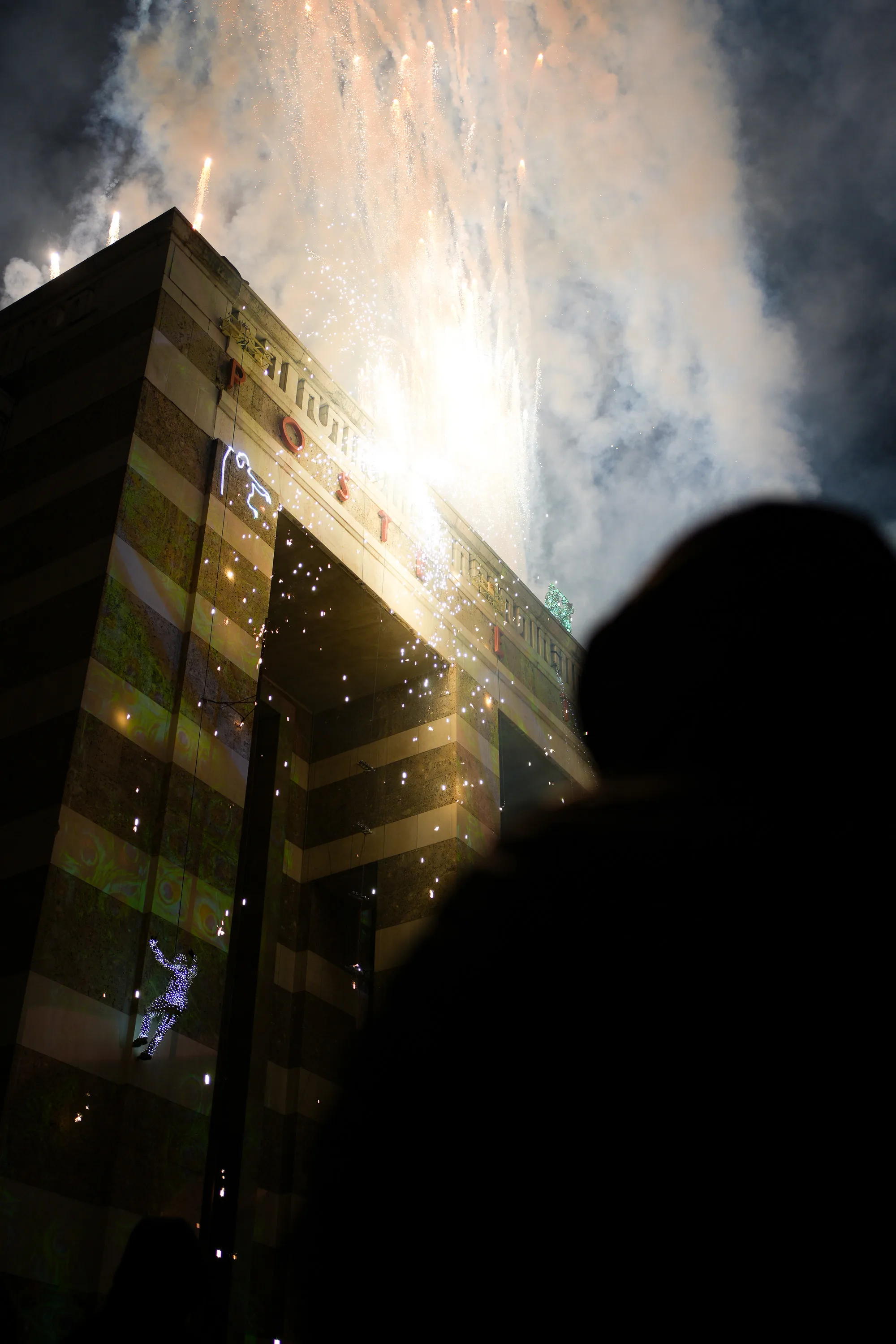 A crowd of people watching a fireworks display.