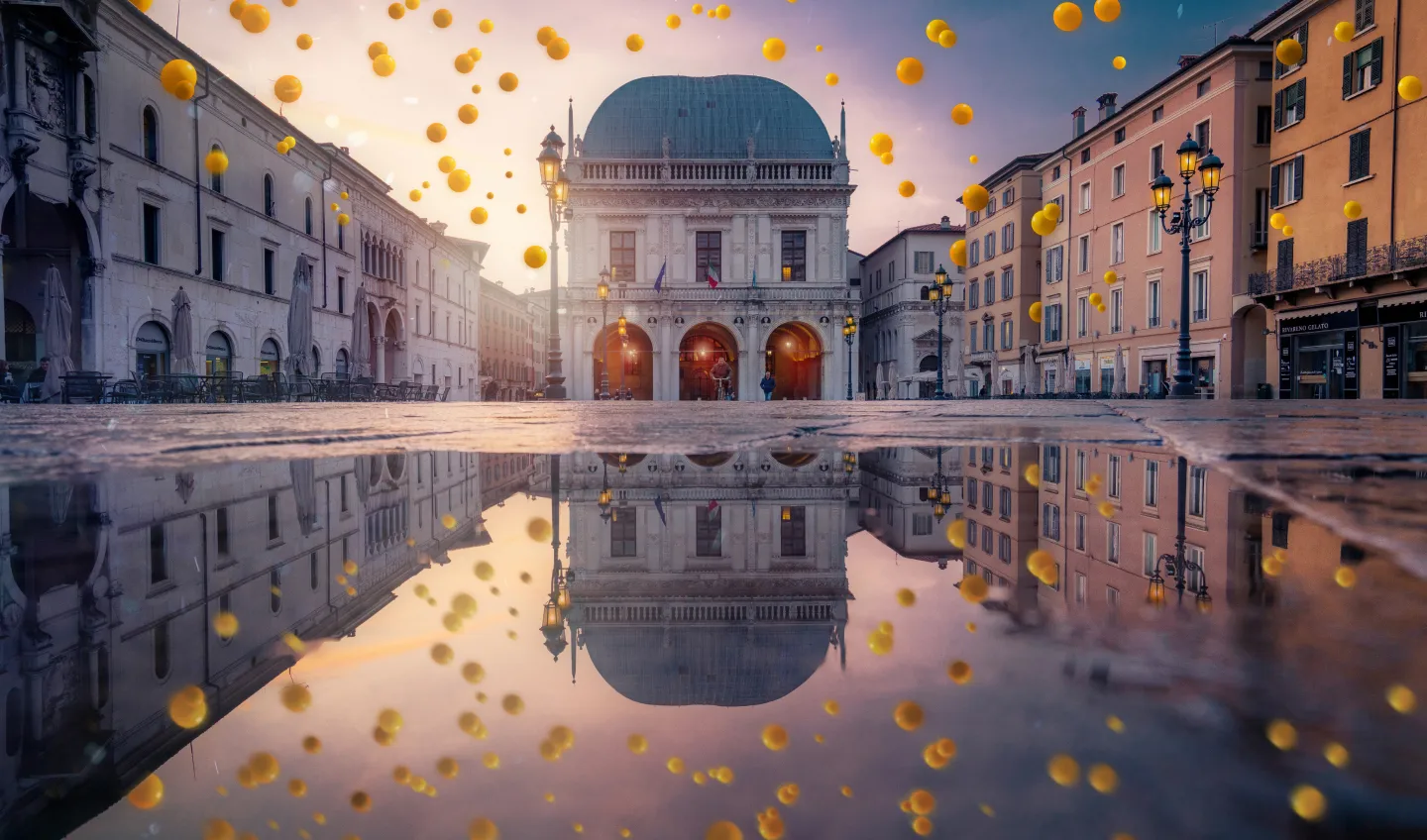 A reflection of a building in a puddle of water.