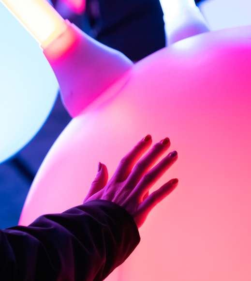 A person reaching out to touch a large balloon.